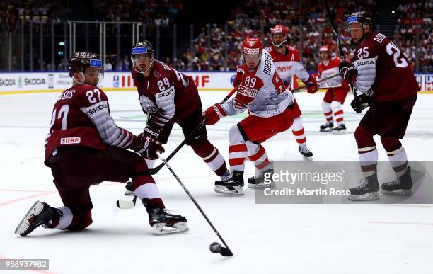 Mikelis Redlihs of Latvia and Mikkel Boedker of Denmark battle for the puck during the 2018 IIHF Ice Hockey World Championship Group B game between...