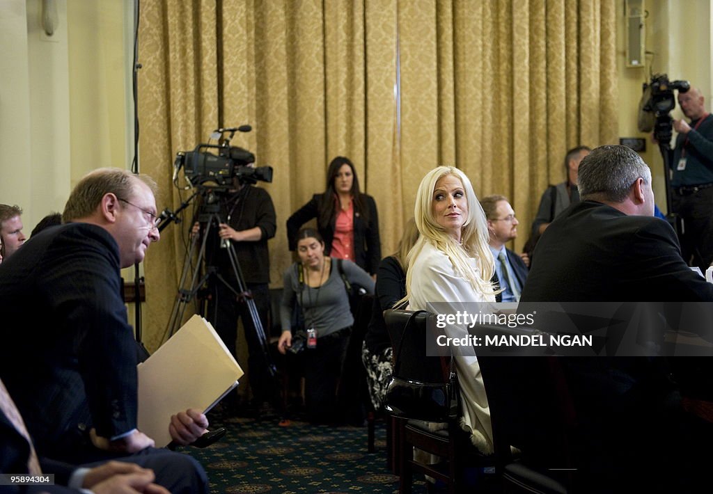 Michaele Salahi (C) looks to her attorne
