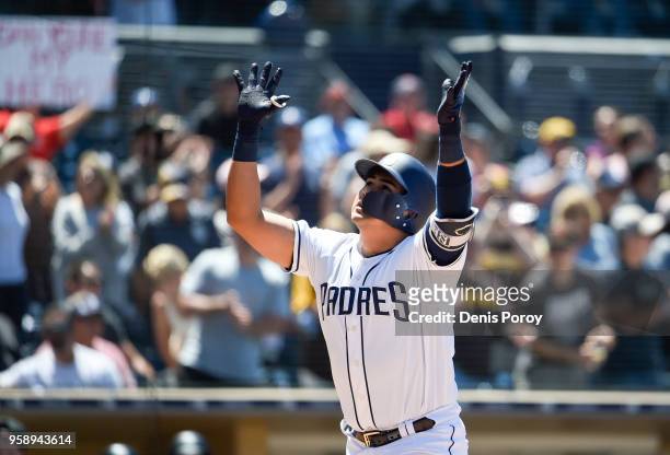 Christian Villanueva of the San Diego Padres points skyward after hitting a two-run home run during the sixth inning of a baseball game against the...
