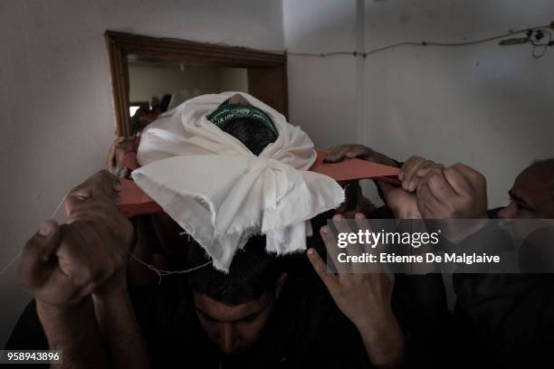 Relatives carry the body of Omar Abu El Fool who was killed yesterday during a protest at the Israel-Gaza border, to his home during his funeral on...