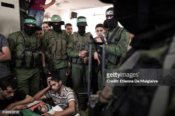 Relatives and members of the Al-Qassam brigades mourn around the body of Omar Abu El Fool who was killed yesterday during a protest at the...