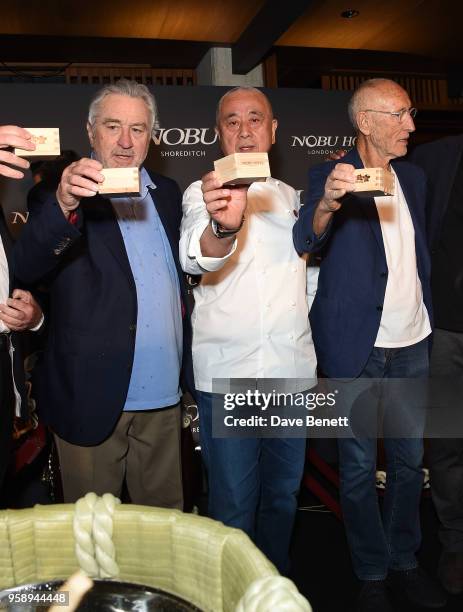 Robert De Niro, Nobu Matsuhisa and Meir Teper pose with a toast of sake at the Nobu Hotel London Shoreditch official launch event on May 15, 2018 in...