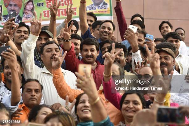 Delhi President Manoj Tiwari with supporters flashes victory sign after BJP emerged as the single largest party in Karnataka Assembly elections on...