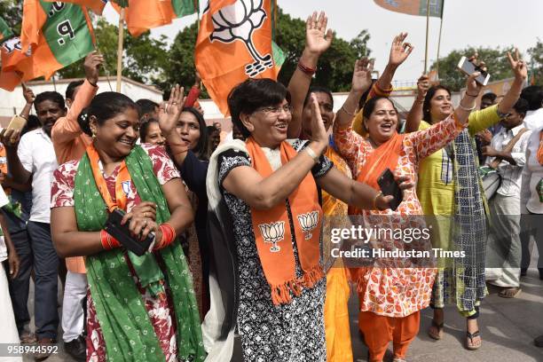 Workers celebrate at party headquarter after BJP emerged as the single largest party in Karnataka Assembly elections on May 15, 2018 in New Delhi,...