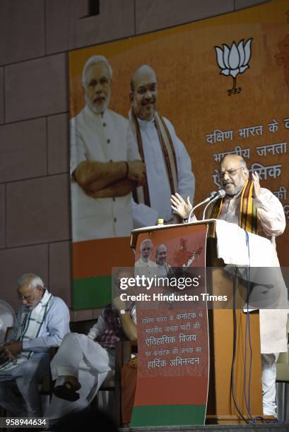 President Amit Shah addresses party workers at the party headquarters after BJP emerged as the single largest party in Karnataka Assembly elections...