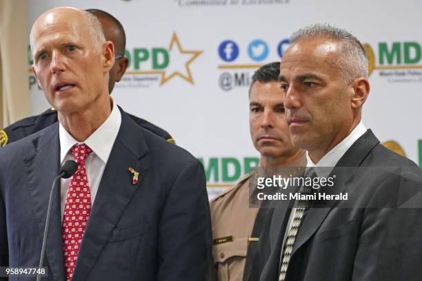 Florida Gov. Rick Scott, left, talks alongside Andrew Pollack, whose daughter Meadow was murdered in Parkland, and Miami-Dade County mayor Carlos A....