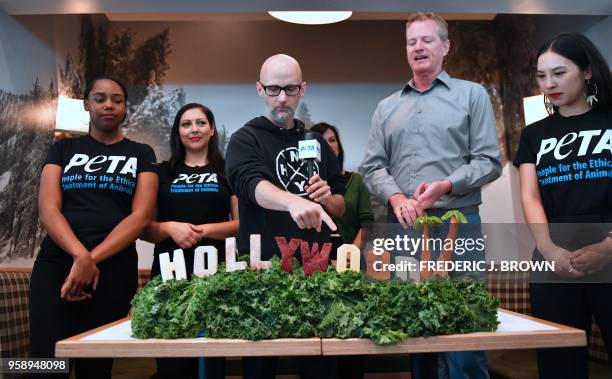 Famed electronic DJ and restauranteur Moby points as Dan Matthews of PETA talks about the vegatbles used for the recreation of the Hollywood Sign...