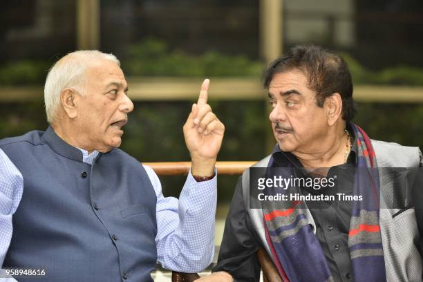 Former BJP leader Yashwant Sinha and BJP MP Shatrughan Sinha speak to each other at ex-IFS officer Prabhu Dayal's book launch at India International...