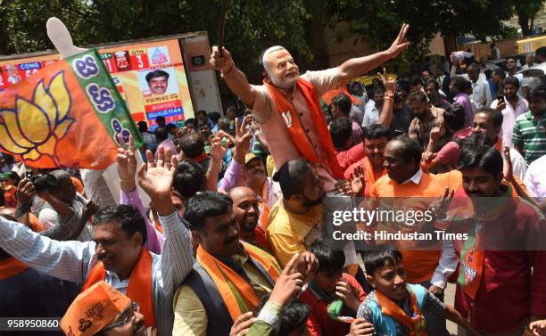 Bharatiya Janata Party supporters celebrate outside the BJP office after the Karnataka poll result on May 15, 2018 in Bengaluru, India.