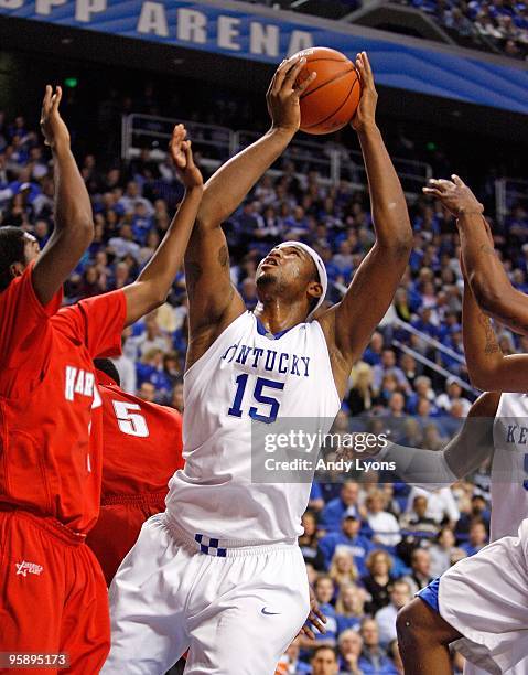 DeMarcus Cousins of the Kentucky Wildcats shoots the ball while defended by Morgan Sabia of the Hartford Hawks during the game at Rupp Arena on...