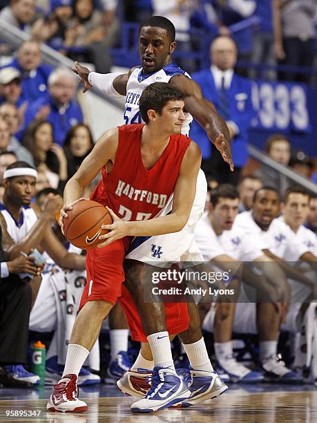 Patrick Patterson of the Kentucky Wildcats puts defensive pressure on Morgan Sabia of the Hartford Hawks during the game at Rupp Arena on December...