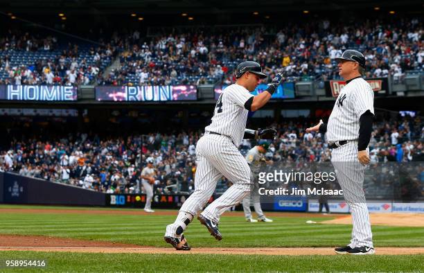 Gary Sanchez of the New York Yankees celebrates his second inning home run against the Oakland Athletics with third base coach Phil Nevin at Yankee...