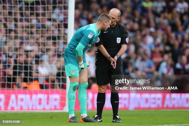 Match referee Mike Dean talking to Sam Johnstone of Aston Villa during the Sky Bet Championship Play Off Semi Final:Second Leg match between Aston...