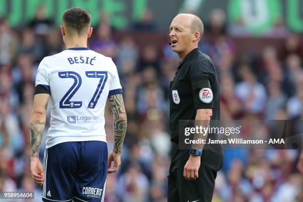 Match referee Mike Dean winks at Muhamed Besic of Middlesbrough during the Sky Bet Championship Play Off Semi Final:Second Leg match between Aston...