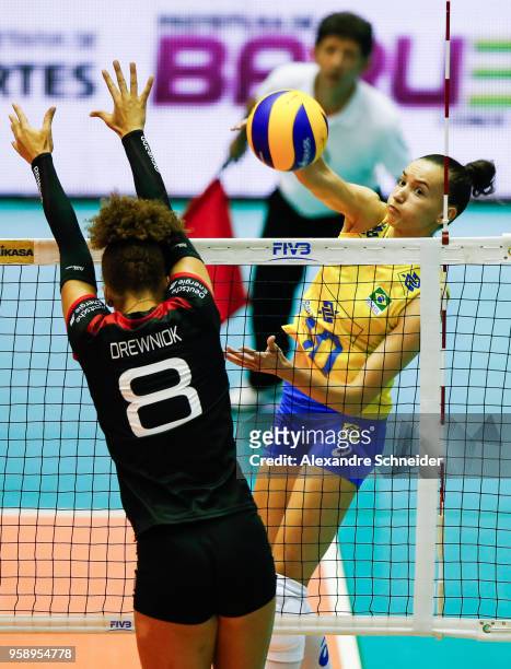 Kimberly Drewnick of Germany tries to block the ball against Gabriela Guimaraes of Brazil during the FIVB Volleyball Nations League 2018 at Jose...