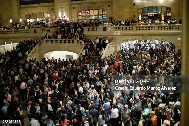 Commuters wait for train service to be restored after a severe thunderstorm downed trees that caused power outages resulting in several Metro-North...