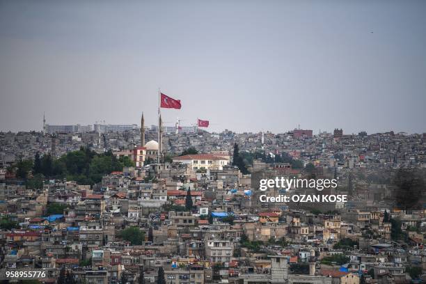 Flags flutter over Gaziantep, in the south-west province of Turkey, on May 1, 2018. - In the Turkish city of Gaziantep, home to around half a million...