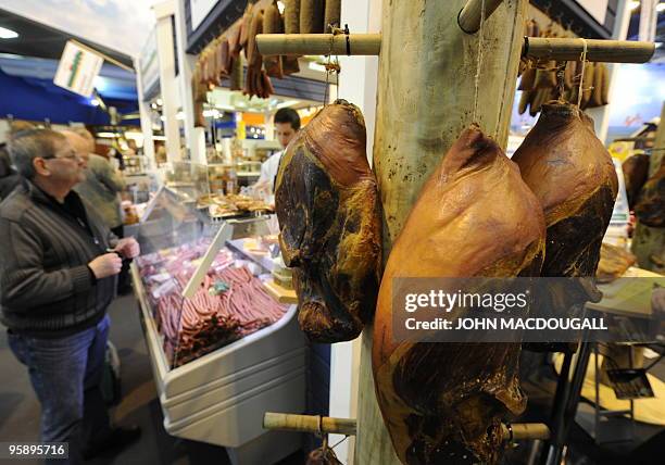 Legs of ham are on display at a stand selling German meat specialties at the International Green Week Food and Agriculture fair in Berlin January 19,...