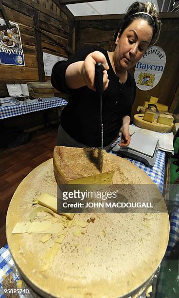 Worker cuts a traditional Bavarian cheese at the International Green Week Food and Agriculture fair in Berlin January 19, 2010. The fair, the largest...