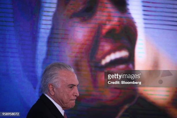 Michel Temer, Brazil's president, pauses while speaking during a ceremony marking his second year in office at the Planalto Palace in Brasilia,...