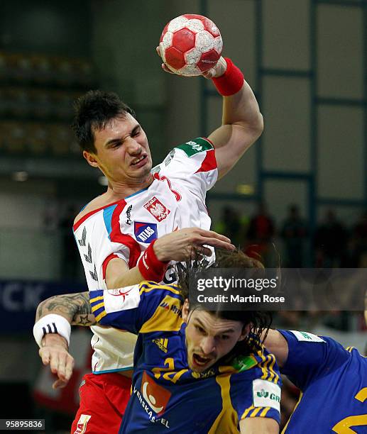 Krysztof Lijewski of Poland tackles Frederik Petersen of Sweden during the Men's Handball European Championship Group C match between Poland and...