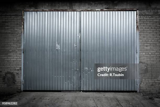 industrial building made of grungy concrete with door - door hanger stock pictures, royalty-free photos & images