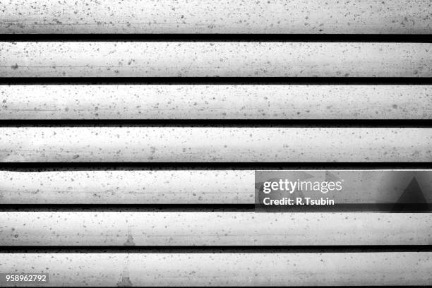 grey shutters over a shop doors - texture - volet à lames photos et images de collection