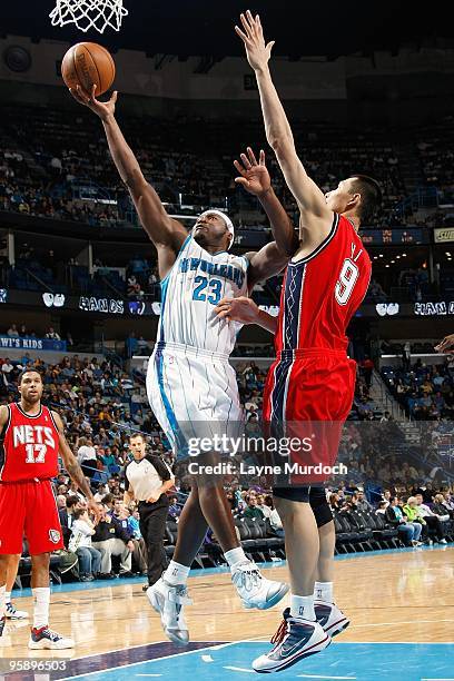 Devin Brown of the New Orleans Hornets goes to the basket against Yi Jianlian of the New Jersey Nets during the game on January 8, 2010 at the New...