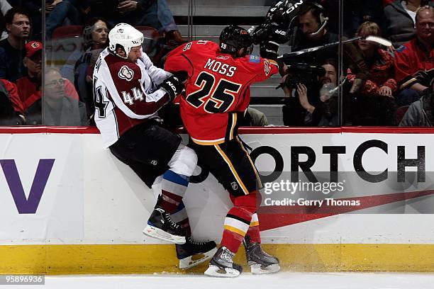 David Moss of the Calgary Flames skates checks Ryan Wilson of the Colorado Avalanche on January 11, 2010 at Pengrowth Saddledome in Calgary, Alberta,...