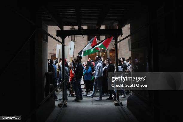 Members of the Palestinian community and their supporters march toward the Israeli consulate to protest President Donald Trump's decision to move the...