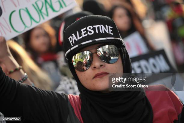 Members of the Palestinian community and their supporters march toward the Israeli consulate to protest President Donald Trump's decision to move the...