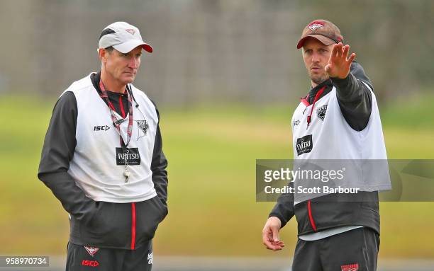 John Worsfold , coach of the Bombers looks on as James Kelly, Performance Coach gestures during an Essendon Bombers AFL training session at The...