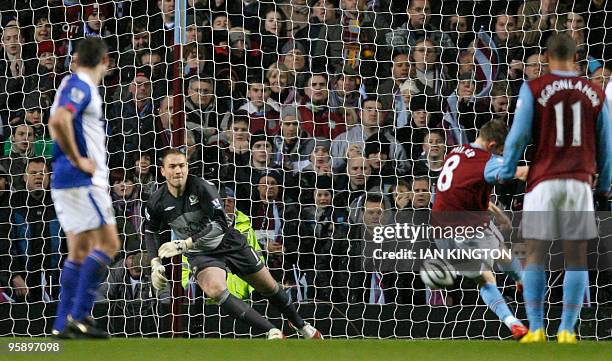 Aston Villa's James Milner scores his penalty beating Blackburn Rovers' goalkeeper Paul Robinson during the league cup semi final second leg football...