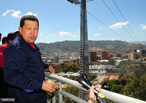 Venezuela's President Hugo Chavez answers journalists' questions during the inauguration of the Caracas aerial tramway on January 20 at a low income...