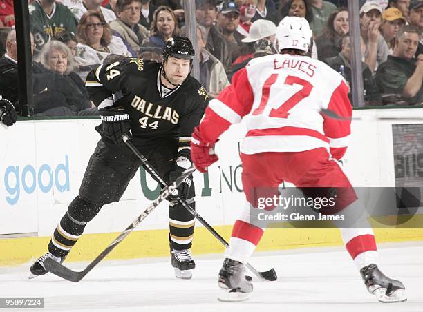 Jeff Woywitka of the Dallas Stars handles the puck against Patrick Eaves of the Detroit Red Wings on January 16, 2010 at the American Airlines Center...