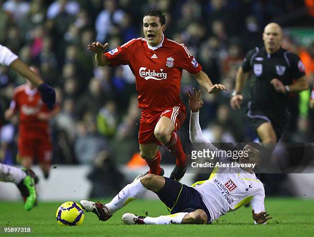 Philipp Degen of Liverpool is tackled by Jermaine Jenas of Tottenham Hotspur during the Barclays Premier League match between Liverpool and Tottenham...