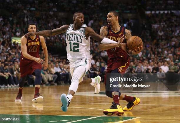 Terry Rozier of the Boston Celtics attempts to steal the ball from George Hill of the Cleveland Cavaliers in the first half during Game Two of the...