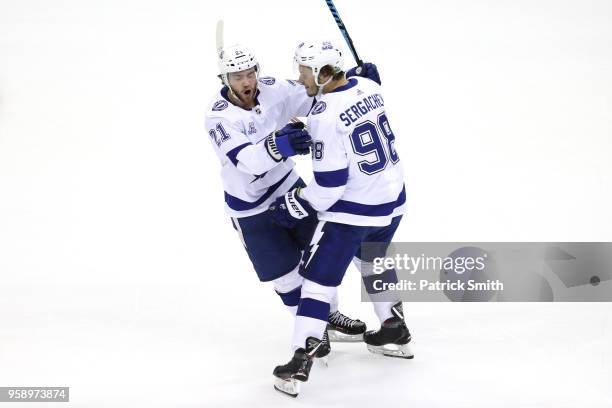 Brayden Point of the Tampa Bay Lightning celebrates with teammate Mikhail Sergachev after scoring a goal on Braden Holtby of the Washington Capitals...