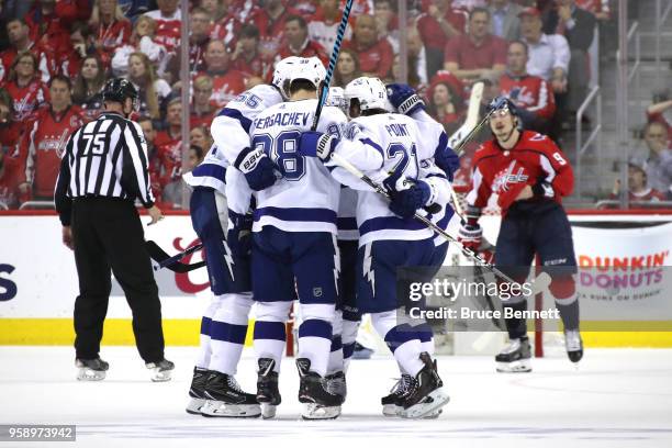 Brayden Point of the Tampa Bay Lightning celebrates with his teammates after scoring a goal on Braden Holtby of the Washington Capitals during the...