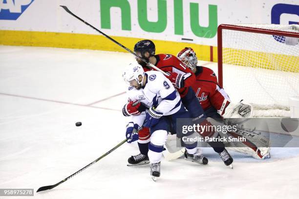 Tyler Johnson of the Tampa Bay Lightning looks for the puck against Brett Connolly of the Washington Capitals in front of Braden Holtby during the...