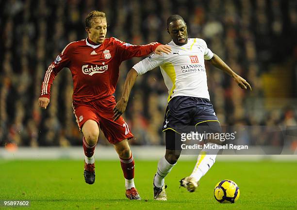 Ledley King of Tottenham Hotspur battles for the ball with Lucas of Liverpool during the Barclays Premier League match between Liverpool and...