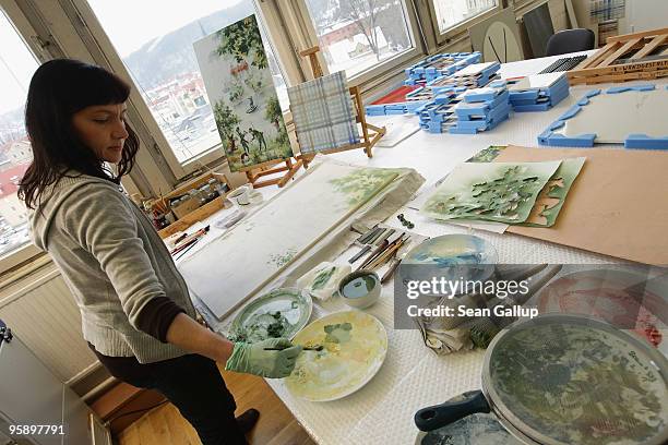 An artisan paints a large wall tile at the manufactury of German luxury porcelain maker Meissen on January 20, 2010 in Meissen, Germany. Officially...