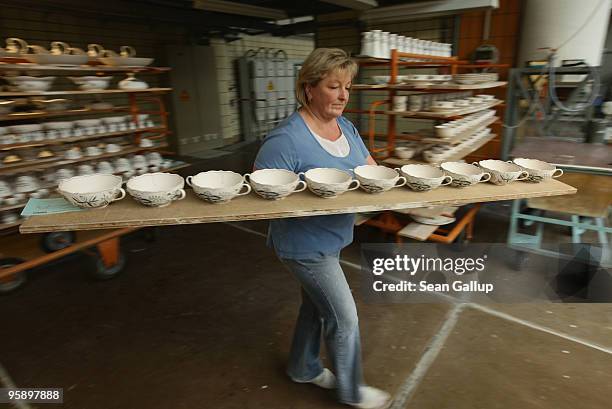 An artisan prepares porcelain bowls for glazing at the manufactury of German luxury porcelain maker Meissen on January 20, 2010 in Meissen, Germany....