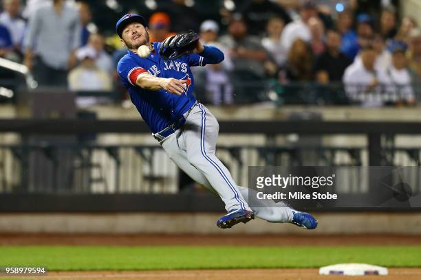 Josh Donaldson of the Toronto Blue Jays is unable to throw out Juan Lagares of the New York Mets in the fifth inning at Citi Field on May 15, 2018 in...