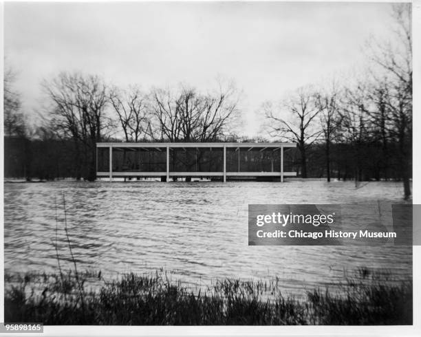 View of the Farnsworth House in Plano, Illinois, surrounded by flood waters so that it almost seems to float, December 1966. Designed by Mies van der...