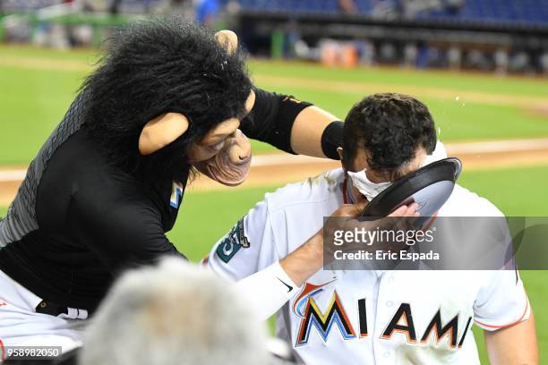 Miguel Rojas of the Miami Marlins puts shaving cream in the face of Martin Prado after defeating the Los Angeles Dodgers at Marlins Park on May 15,...