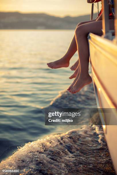 children sitting on sailboat deck while sailing - miljko stock pictures, royalty-free photos & images