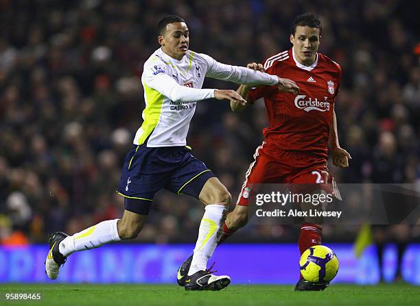 Jermaine Jenas of Tottenham Hotspur tussles for posession with Philipp Degen of Liverpool during the Barclays Premier League match between Liverpool...