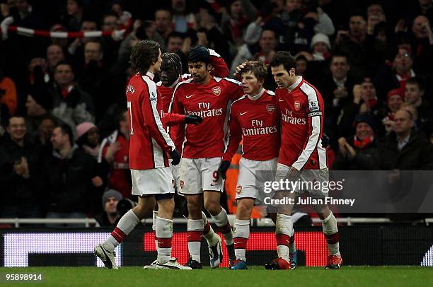 Andrey Arshavin of Arsenal is congratulated after scoring his teams fourth goal during the Barclays Premier League match between Arsenal and Bolton...