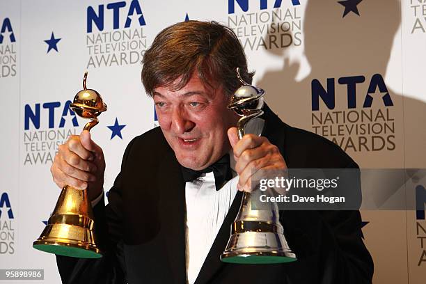 Stephen Fry poses with his most popular documentary and special recognition awards in the press room at the National Television Awards held the at...